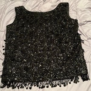 Elegant sequin party top with fringe along bottom.